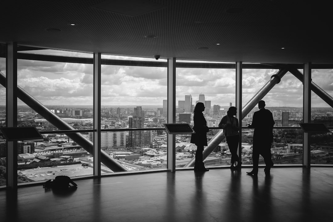 Office view with silhouettes of people looking at city skyline